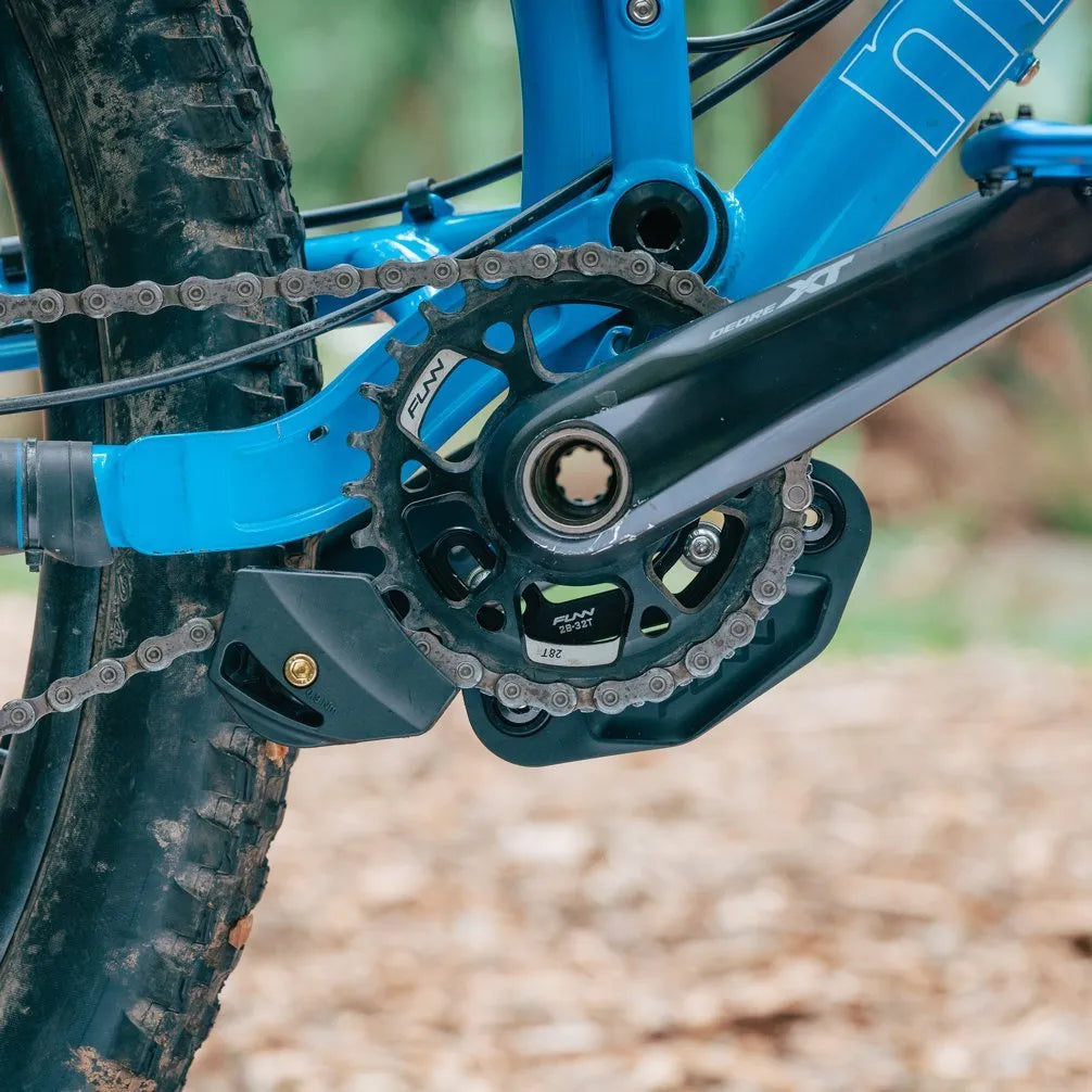 A Funn Zippa LG chain guide and a crankset with a blurred natural background