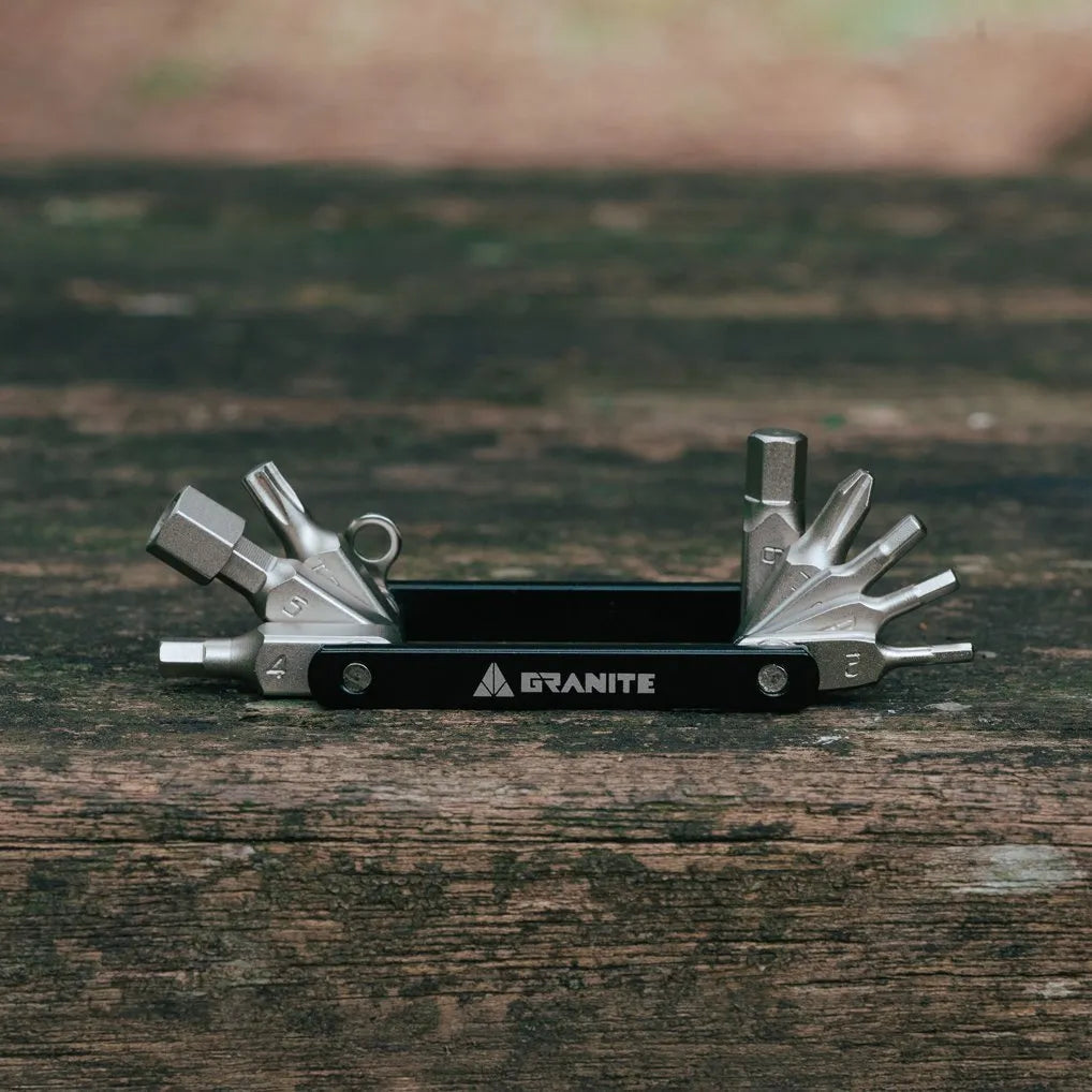 Granite Diverse 10 Multi tool with various components on a wooden surface, brand 'Granite' visible