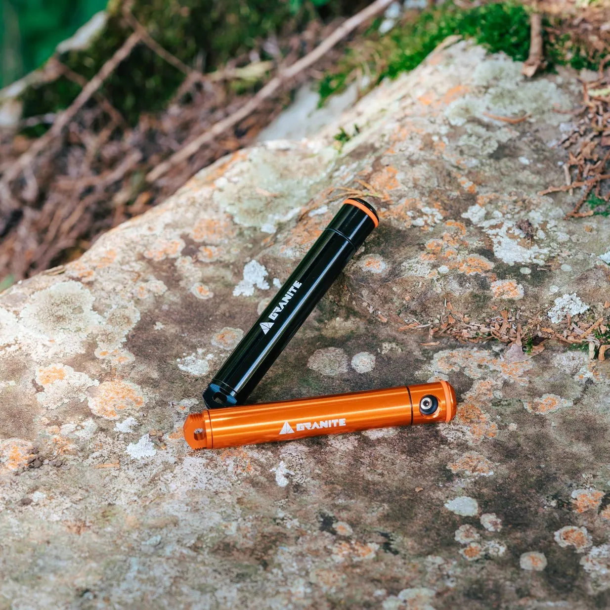 Granite Suture Aero tire plug kit, one black and one orange, with 'Granite' branding, on a textured stone surface.